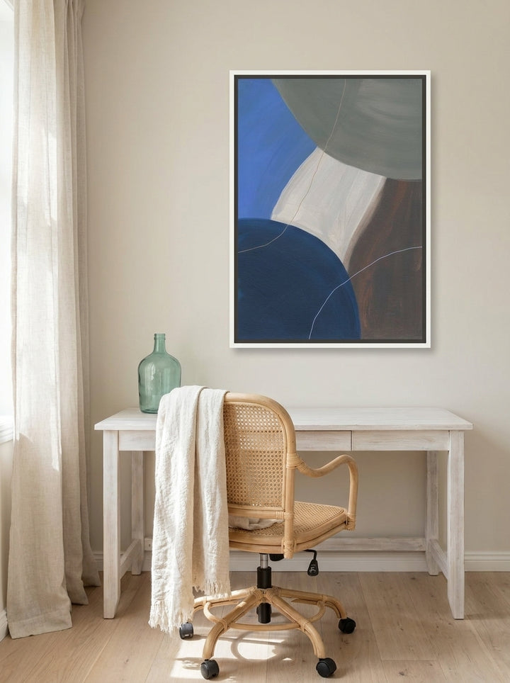 Canvas wall art with a white surround styled on the wall in a coastal home office