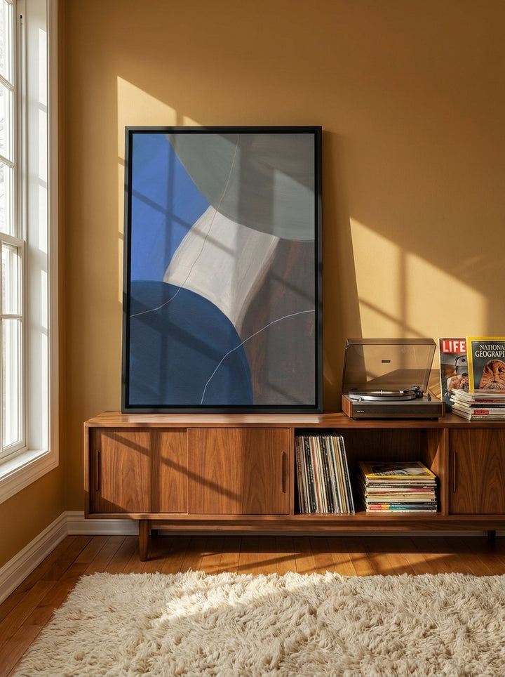 Canvas wall art with a black surround standing on a sideboard in a retro 70s living room