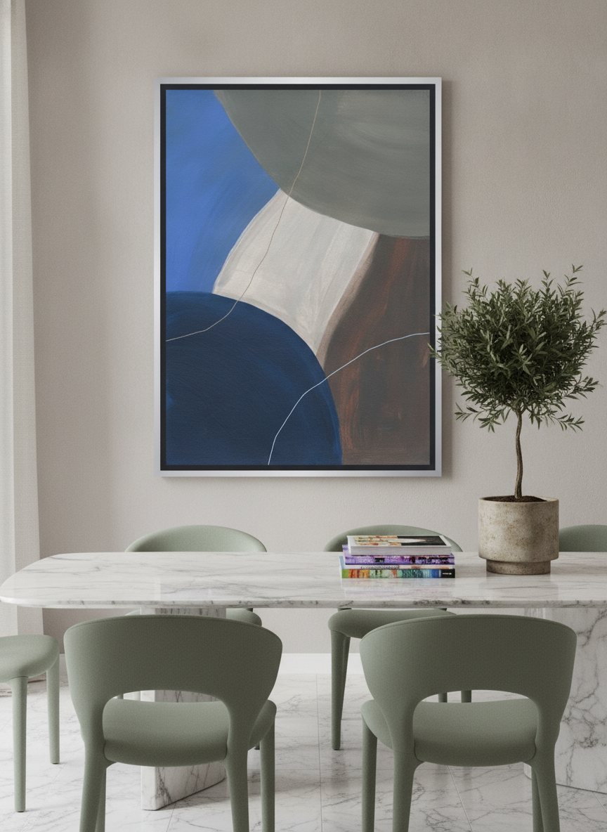 Oversized statement canvas wall art with a silver leaf surround styled on the wall in a luxe dining room