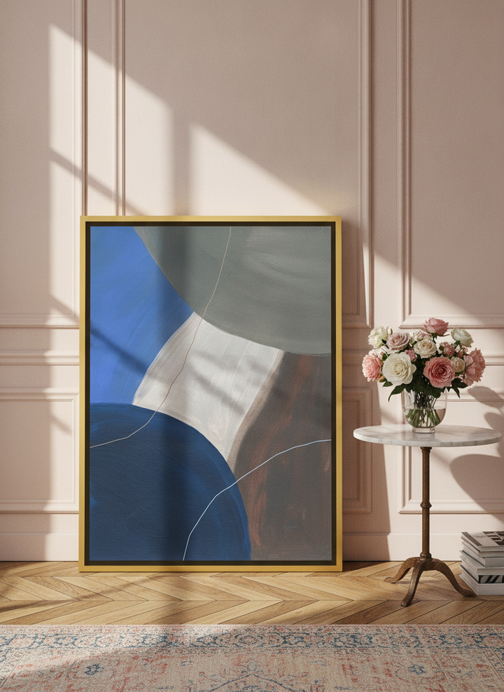 Canvas wall art with a gold leaf surround leaning against the wall in a Parisian bedroom