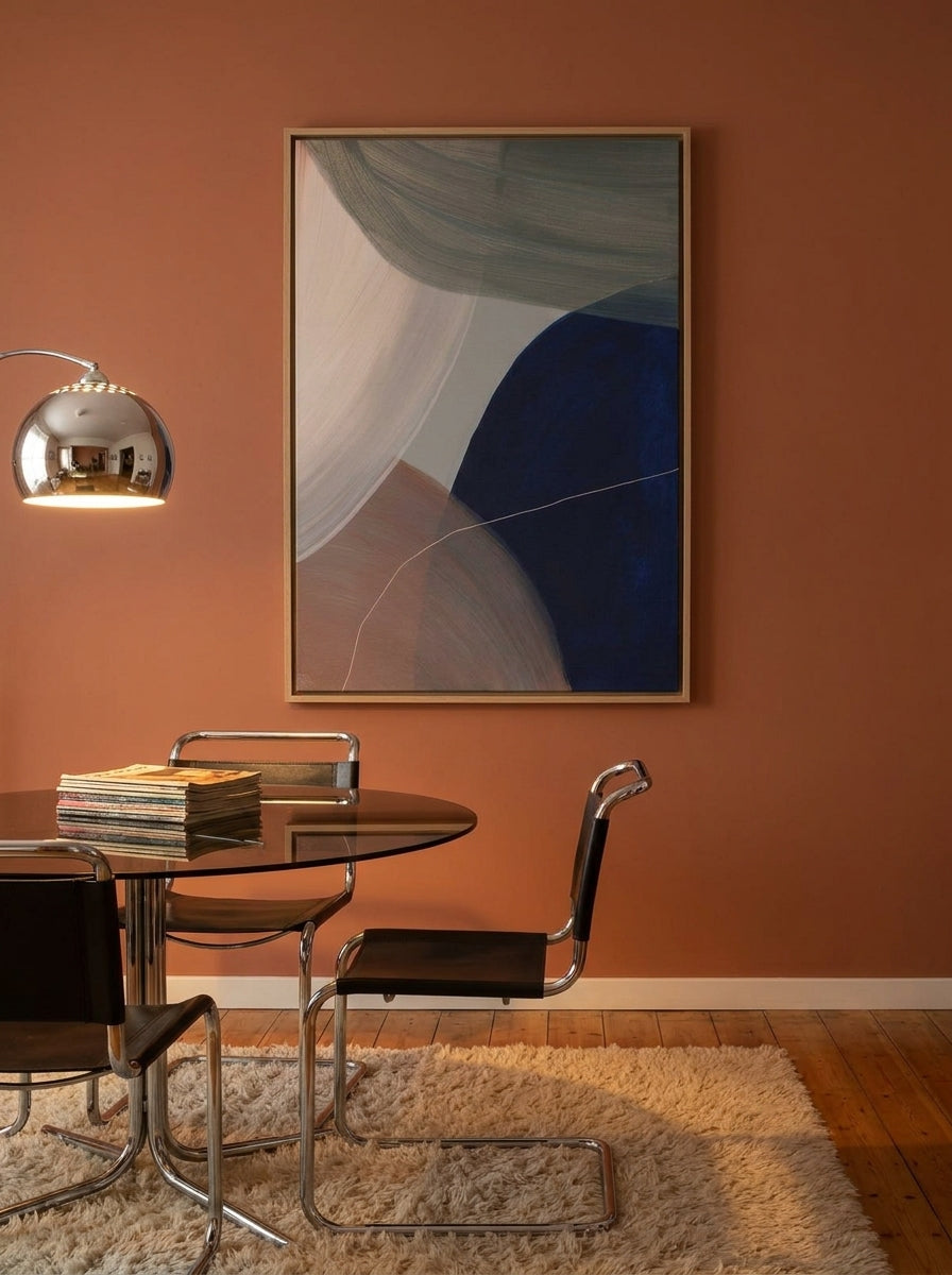 Oversized statement canvas wall art with a natural timber surround styled on the wall in a retro 70s dining room