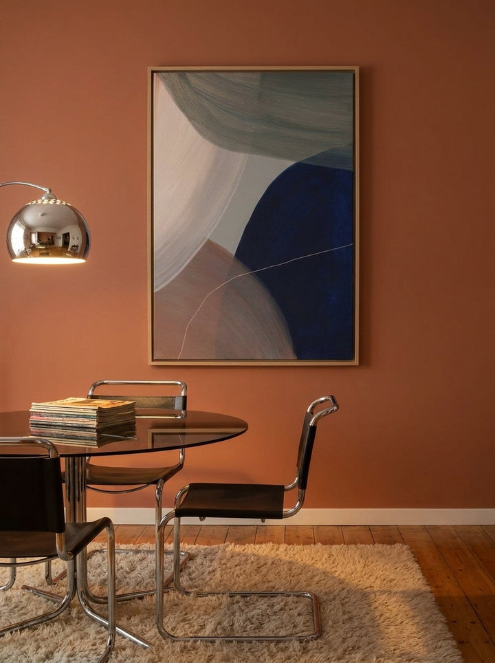 Oversized statement canvas wall art with a natural timber surround styled on the wall in a retro 70s dining room