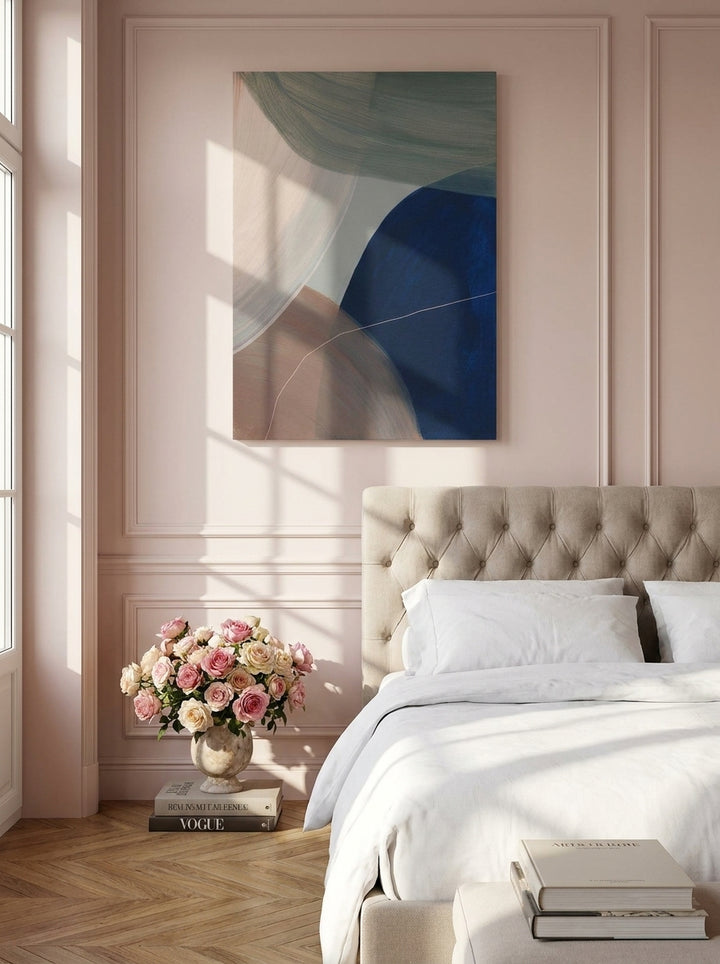 Stretched canvas wall art styled on the wall in a Parisian bedroom