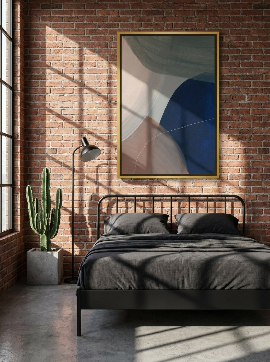 Canvas wall art with a gold leaf surround styled on the wall in an industrial loft bedroom