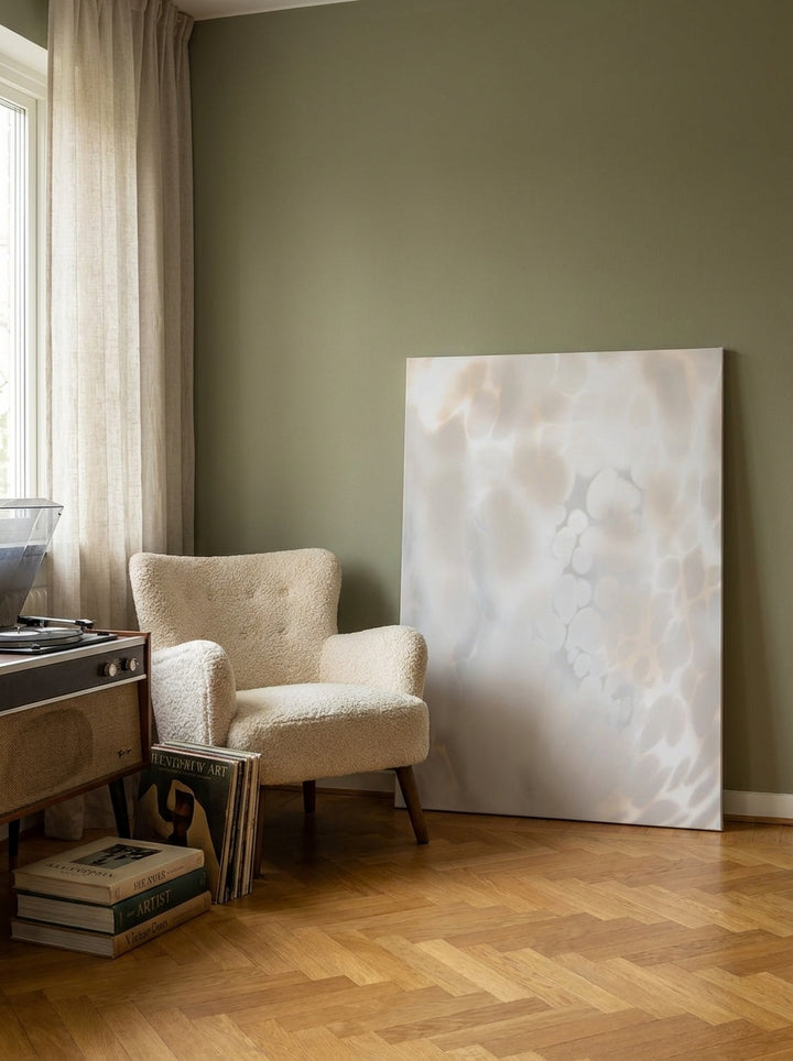 Stretched canvas wall art leaning against the wall in a mid-century living room