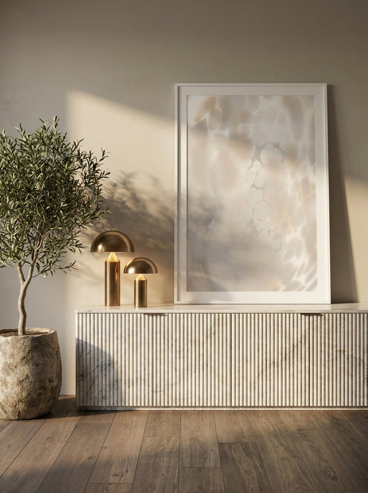 Modern wall art print standing on a sideboard in a luxe bathroom