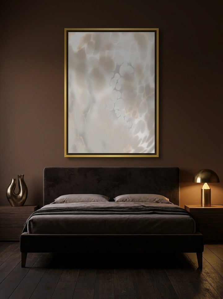Canvas wall art with a gold leaf surround styled on the wall in a moody bedroom