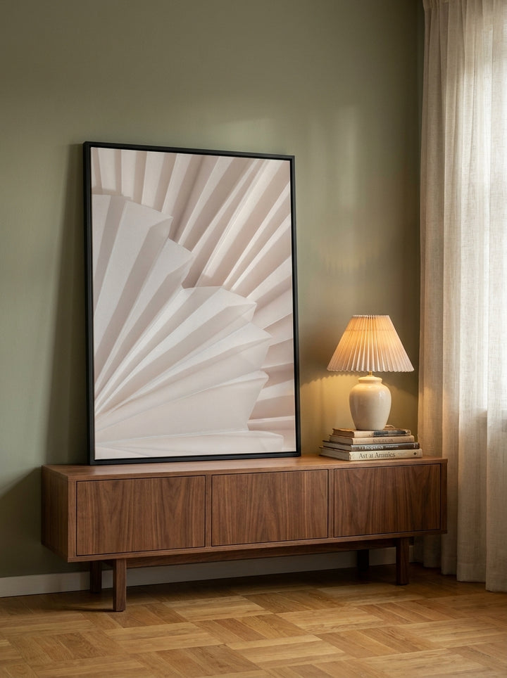 Canvas wall art with a black surround standing on a sideboard in a mid-century home office