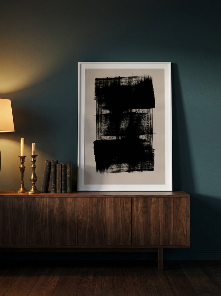 Modern wall art print standing on a sideboard in a moody bedroom
