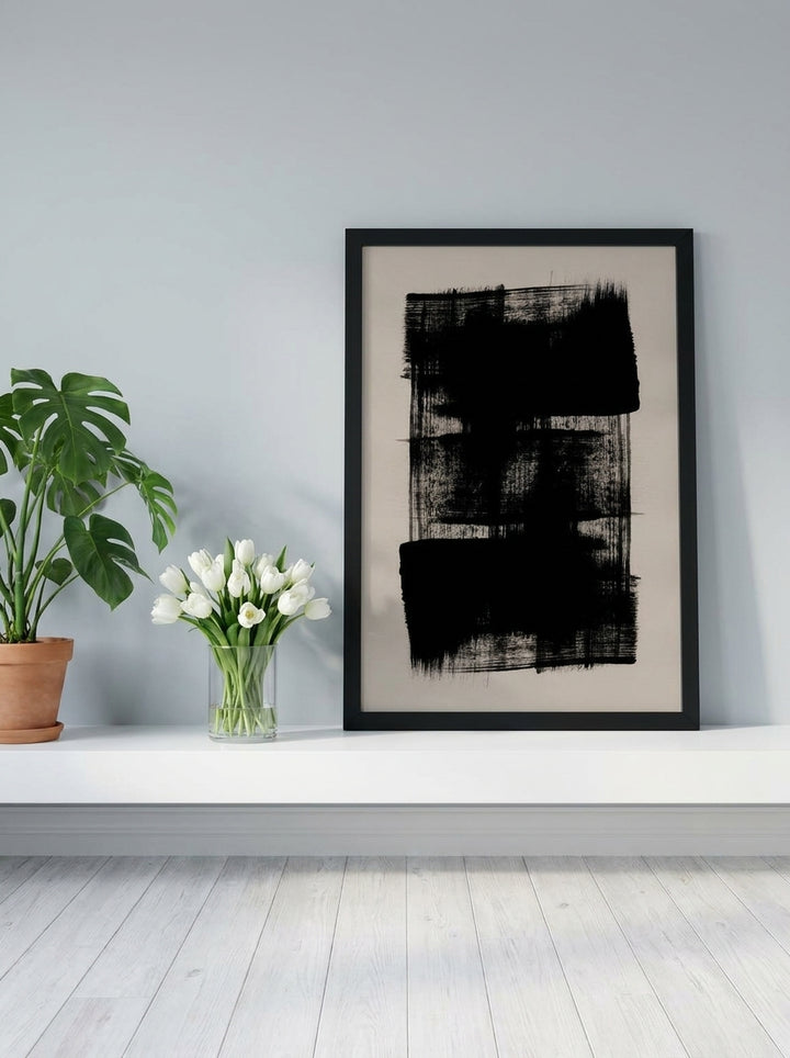 Modern wall art print standing on a shelf in a bright Scandinavian living room