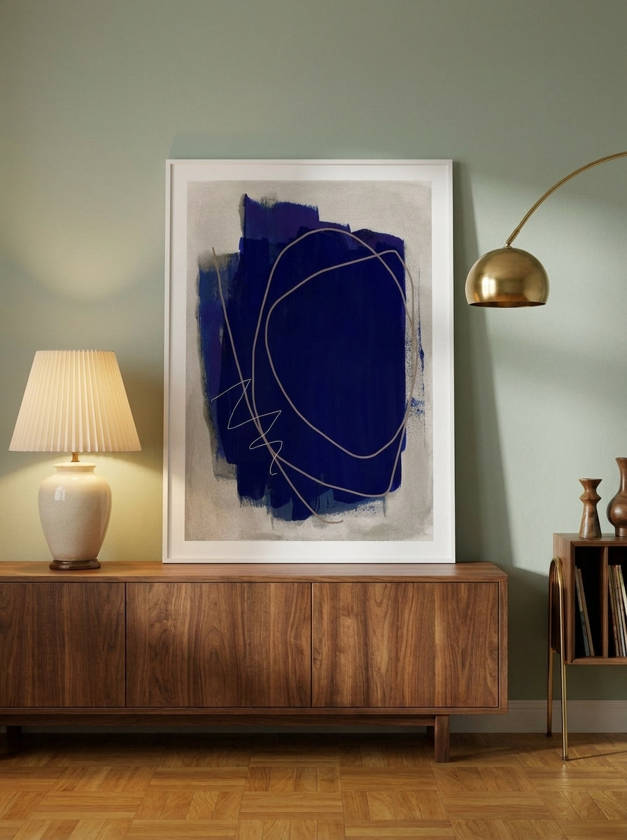 Modern wall art print standing on a sideboard in a mid-century bedroom