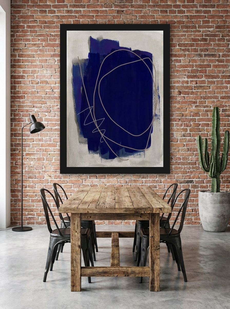 Modern wall art print styled on the wall in an industrial loft dining room