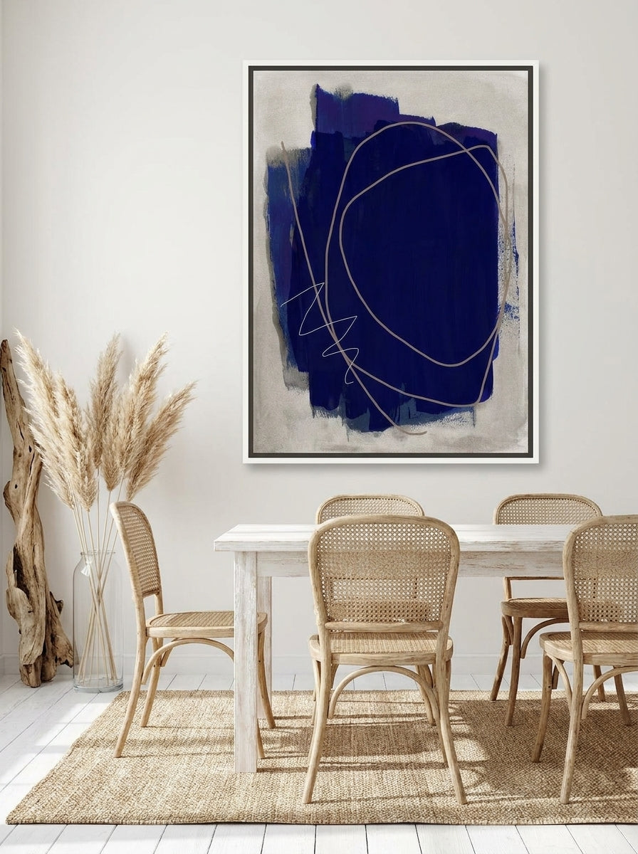 Canvas wall art with a white surround styled on the wall in a coastal dining room