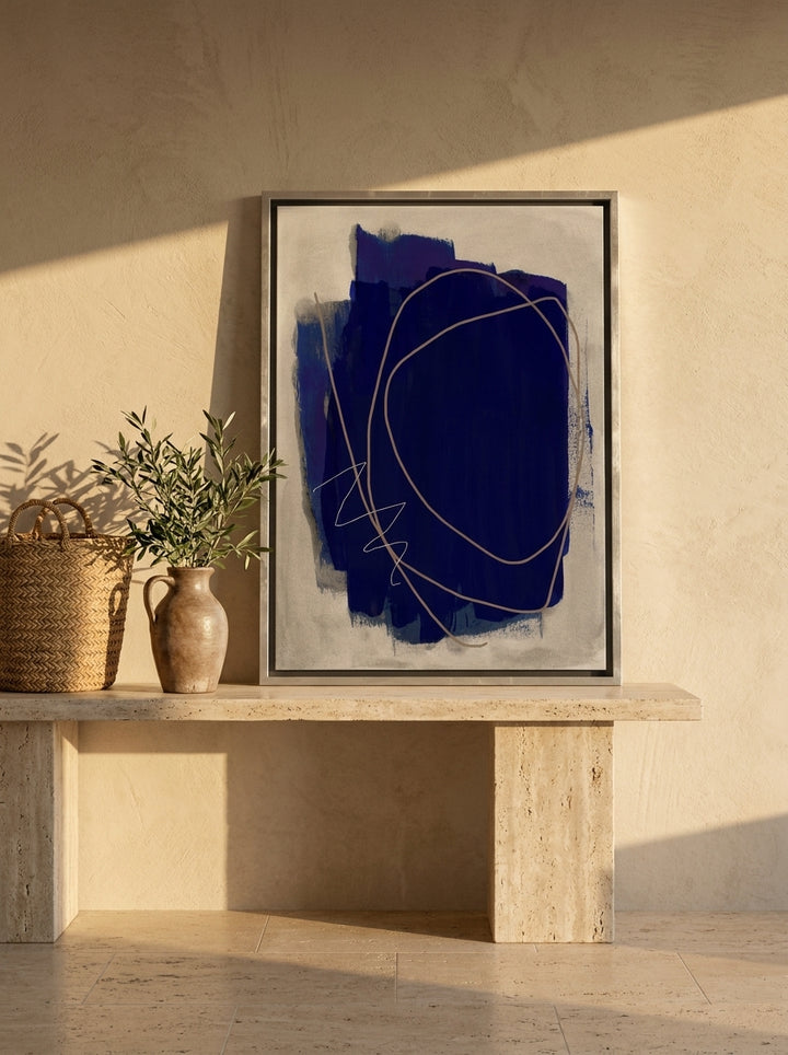 Canvas wall art with a silver leaf surround standing on a console in a Mediterranean home office