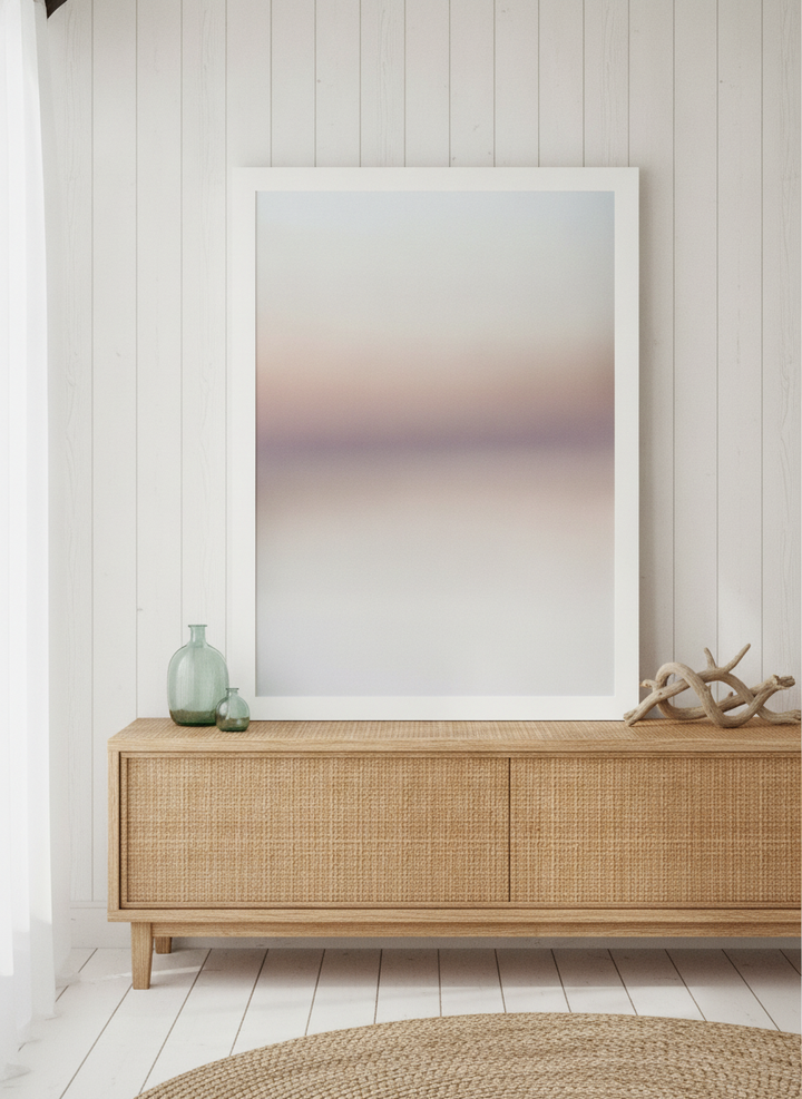 Modern wall art print standing on a sideboard in a coastal bathroom
