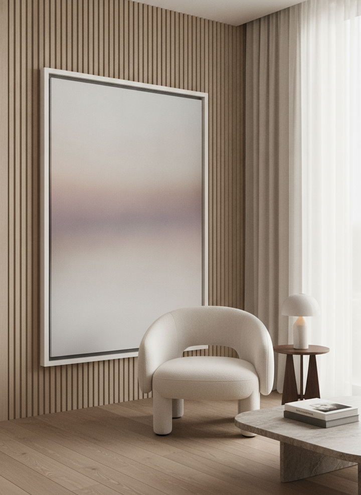 Oversized statement canvas wall art with a white surround leaning against the wall in a luxe living room