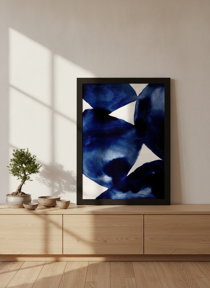 Modern wall art print standing on a sideboard in a warm Japandi bathroom