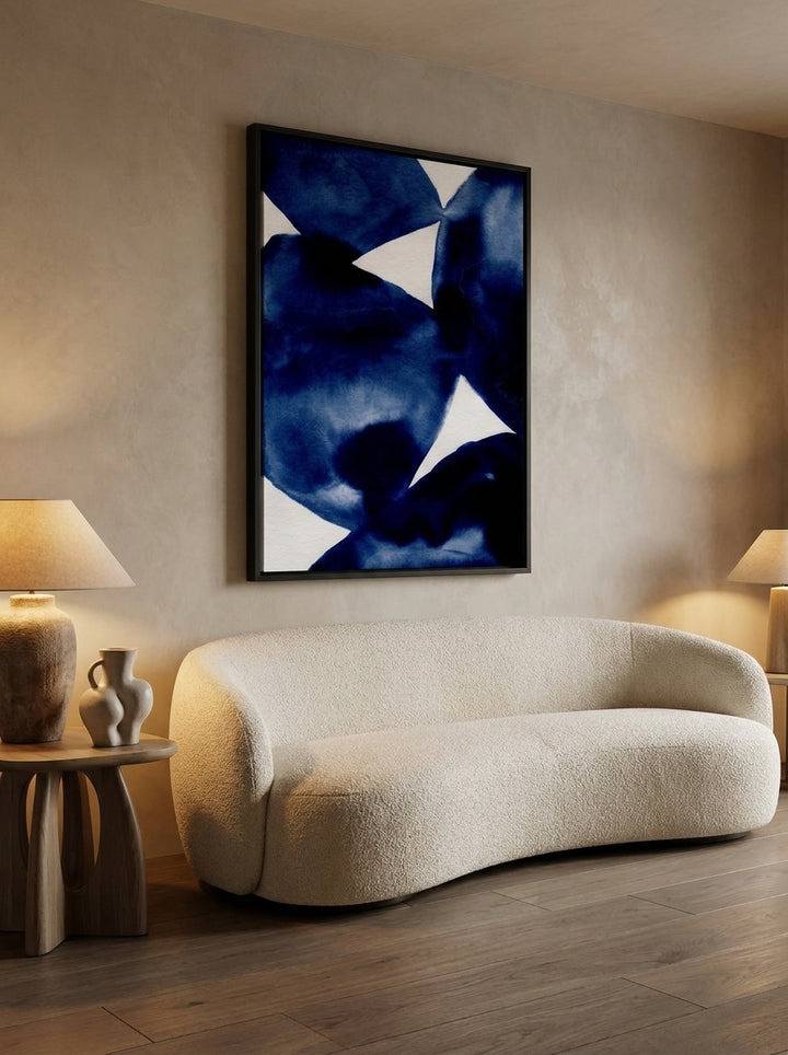 Oversized statement canvas wall art with a black surround styled on the wall in a luxe living room