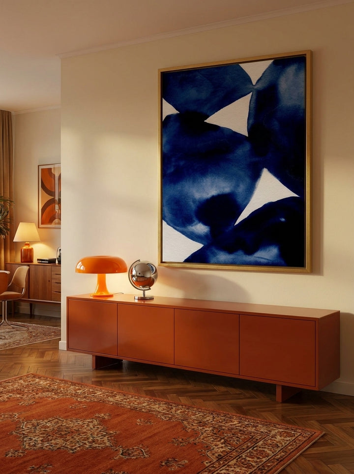 Oversized statement canvas wall art with a gold leaf surround styled on the wall in a retro 70s living room