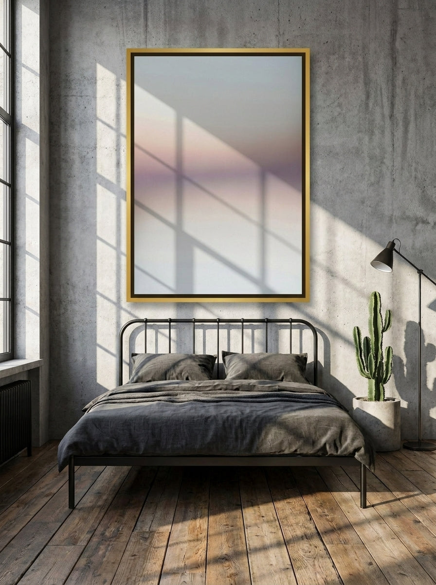 Canvas wall art with a gold leaf surround styled on the wall in an industrial loft bedroom