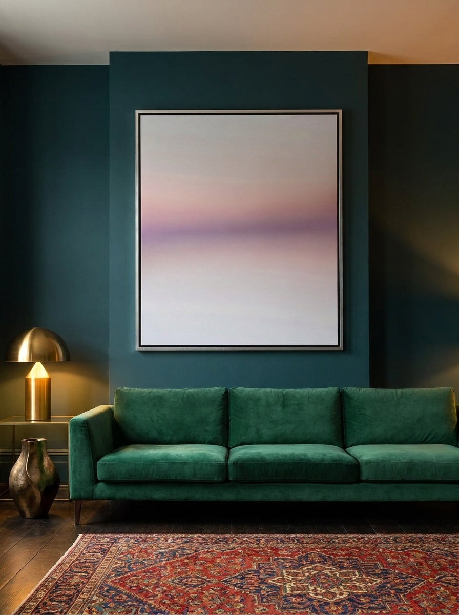 Oversized statement canvas wall art with a silver leaf surround styled on the wall in a moody living room