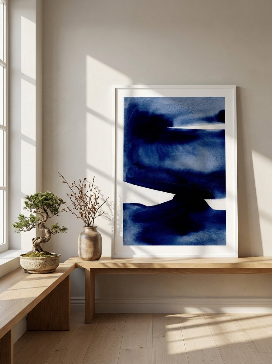 Modern wall art print standing on a bench in a warm Japandi bedroom