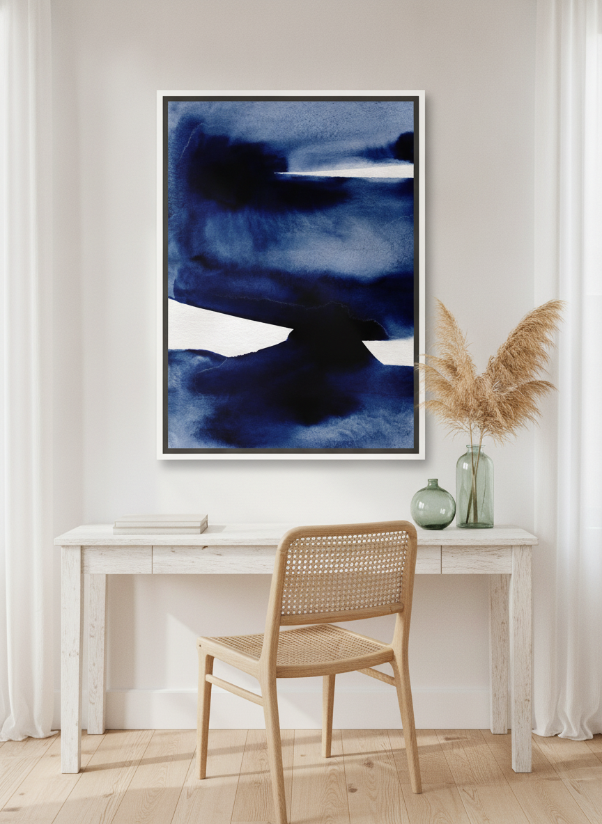 Canvas wall art with a white surround styled on the wall in a coastal home office