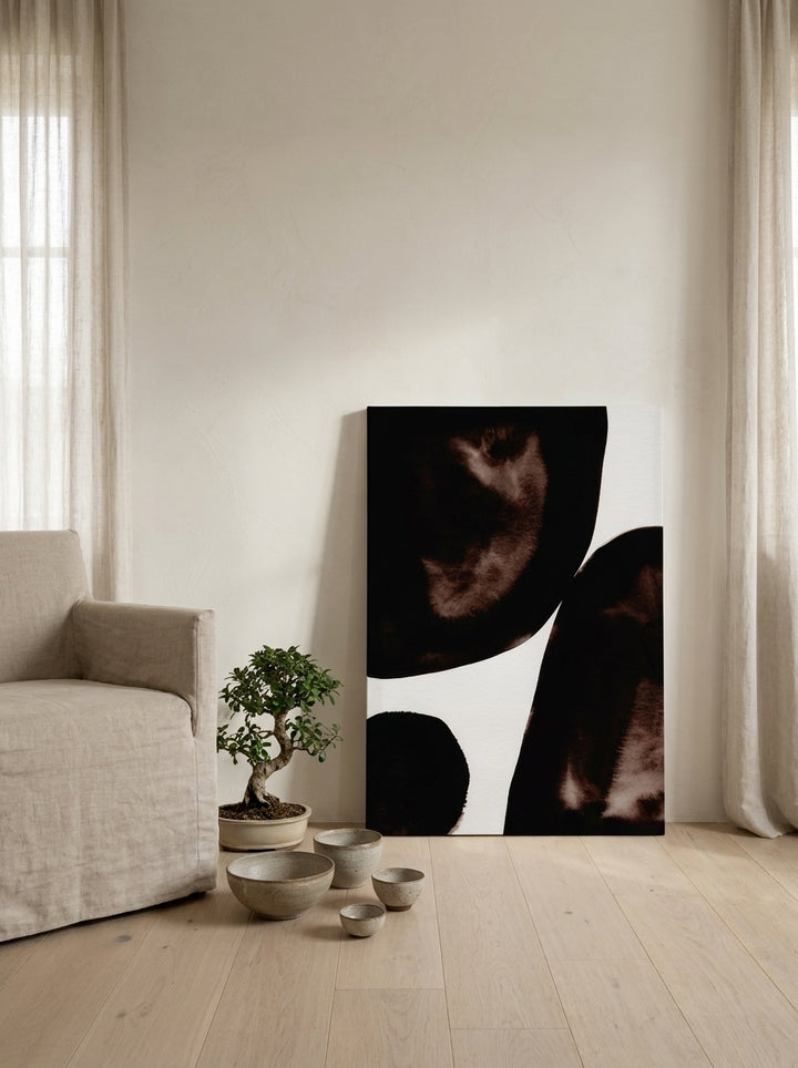 Stretched canvas wall art leaning against the wall in a warm Japandi home office