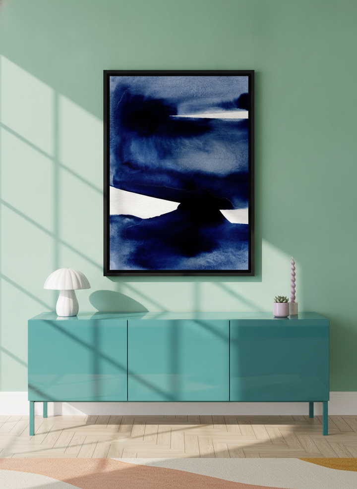 Canvas wall art with a black surround styled on the wall in a colourful eclectic living room