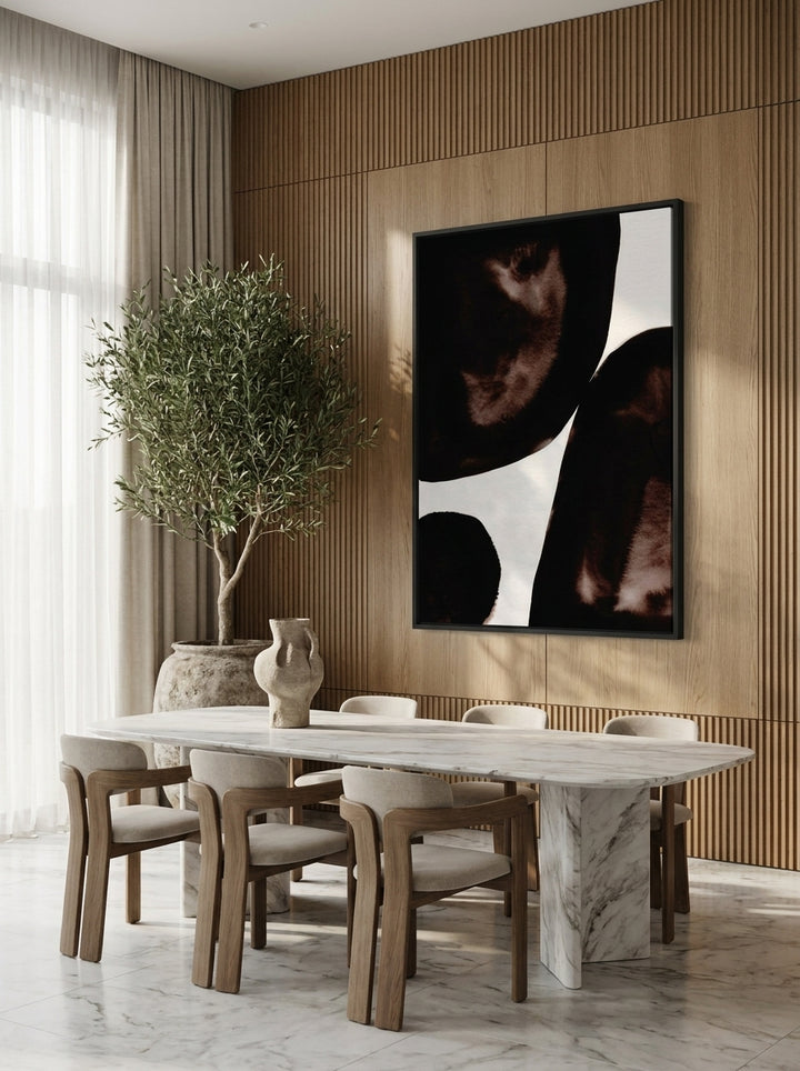 Oversized statement canvas wall art with a black surround styled on the wall in a luxe dining room