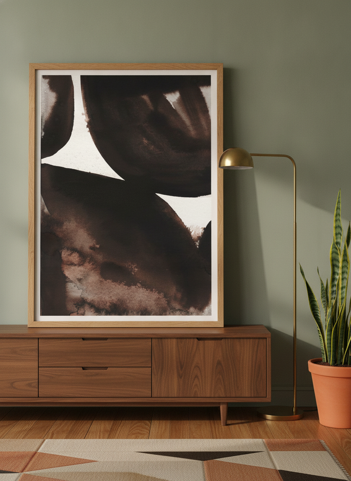 Modern wall art print standing on a sideboard in a mid-century bedroom