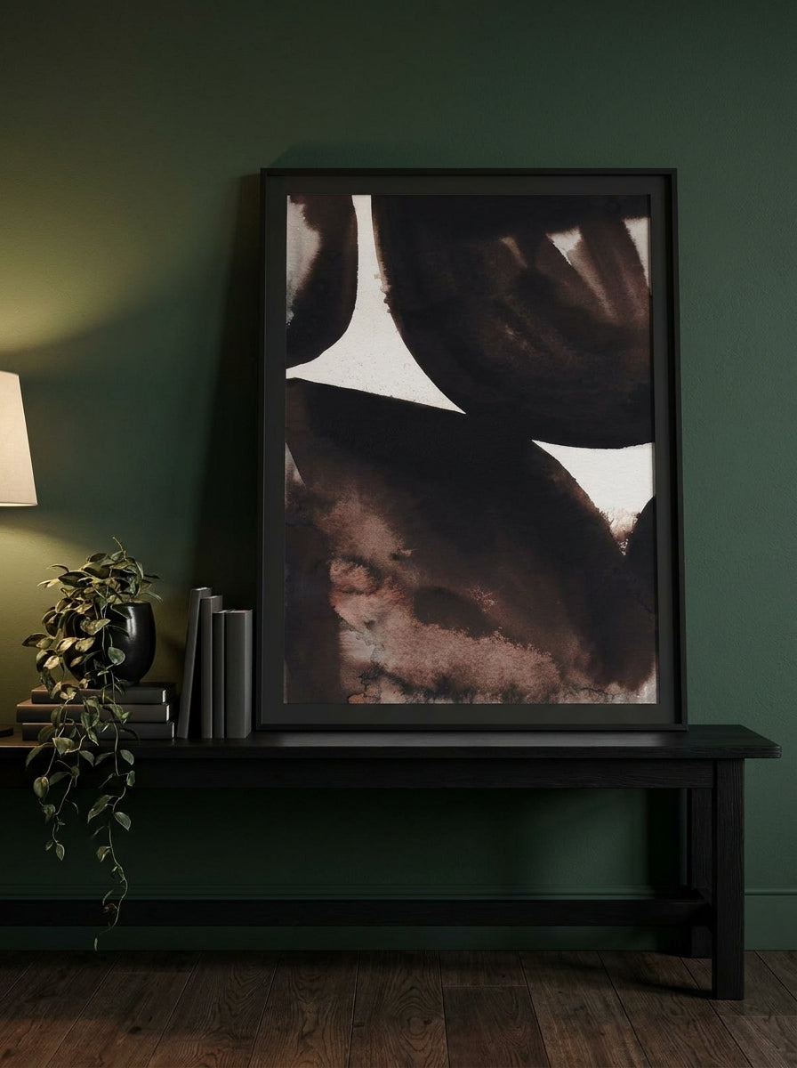 Modern wall art print standing on a console in a moody home office