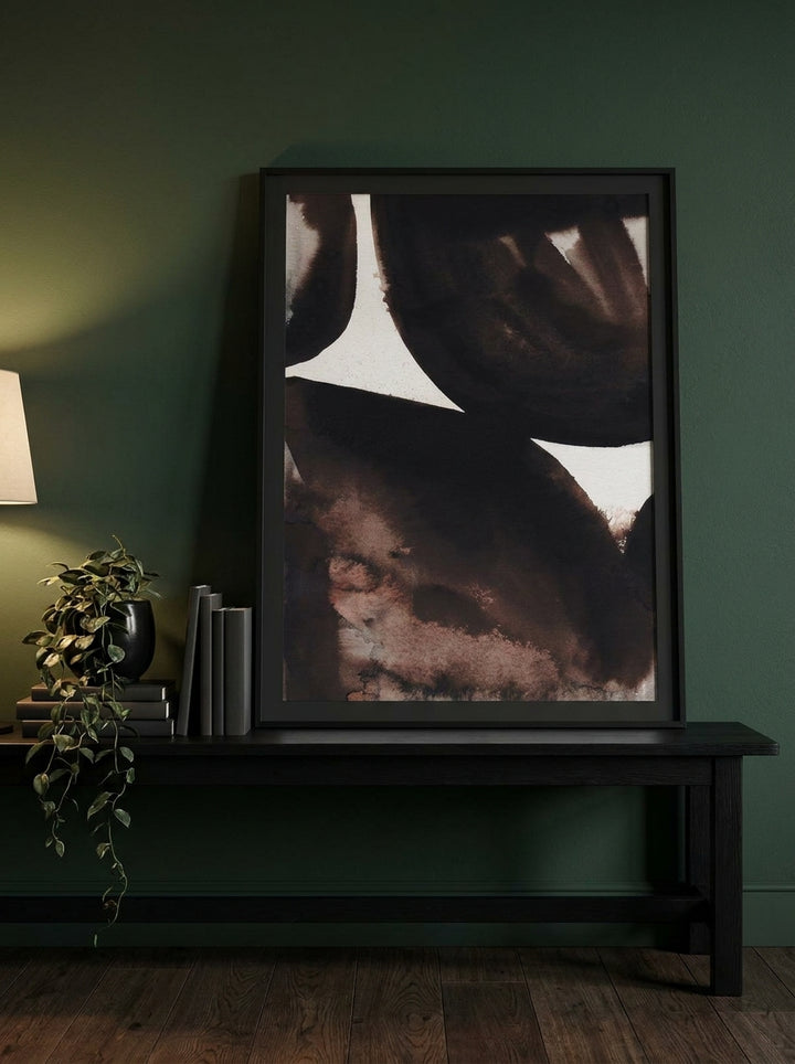Modern wall art print standing on a console in a moody home office