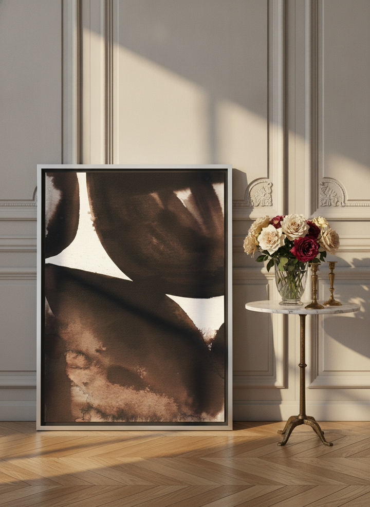 Canvas wall art with a silver leaf surround leaning against the wall in a Parisian home office