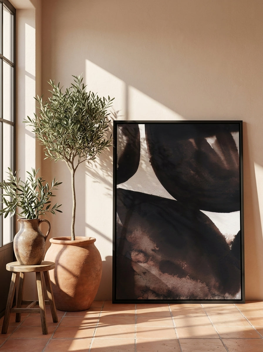 Canvas wall art with a black surround leaning against the wall in a Mediterranean bedroom