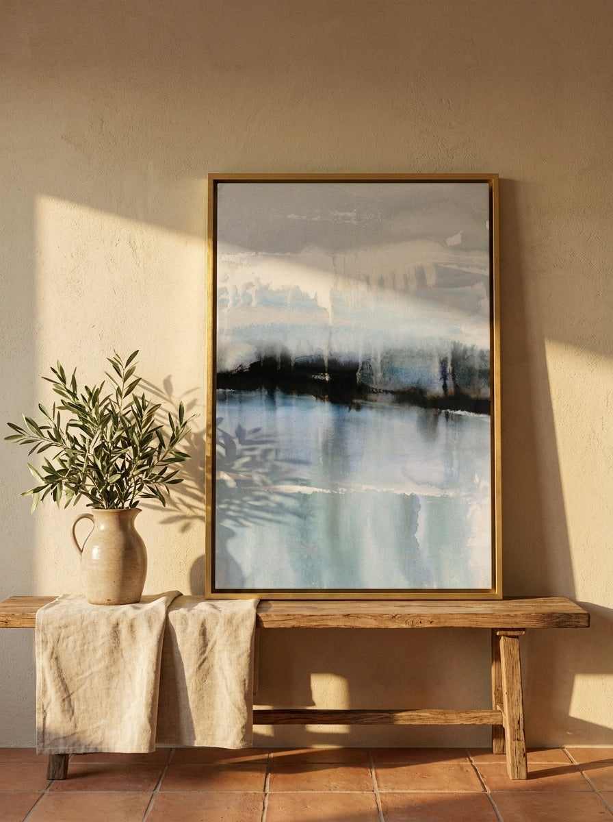 Canvas wall art with a gold leaf surround standing on a bench in a Mediterranean home office