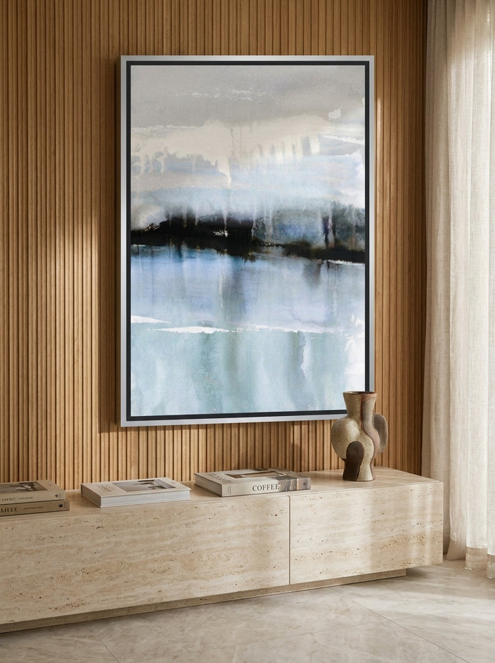 Oversized statement canvas wall art with a silver leaf surround styled on the wall in a luxe living room
