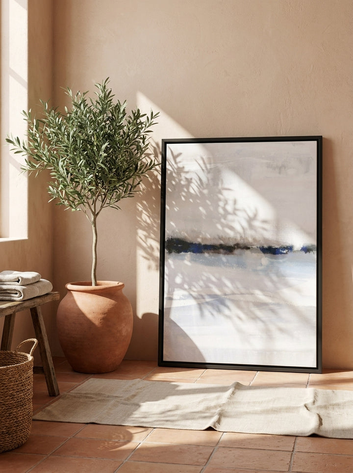 Canvas wall art with a black surround leaning against the wall in a Mediterranean bathroom