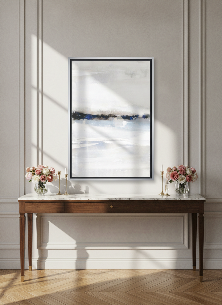 Canvas wall art with a silver leaf surround standing on a console in a Parisian bedroom