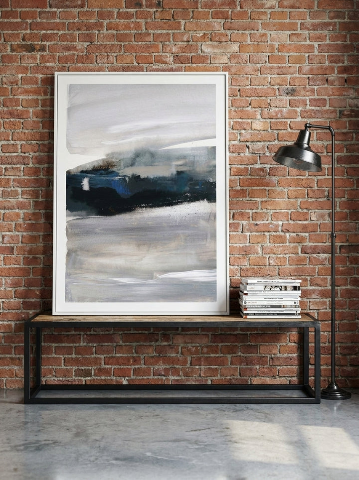 Modern wall art print standing on a console in an industrial loft bedroom