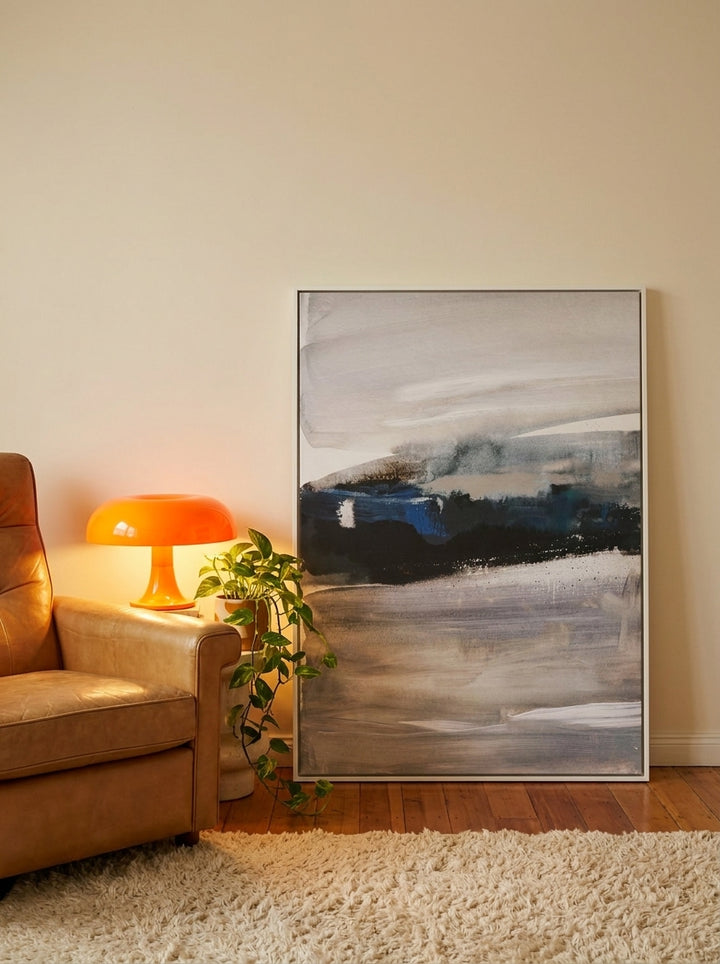 Canvas wall art with a white surround leaning against the wall in a retro 70s home office