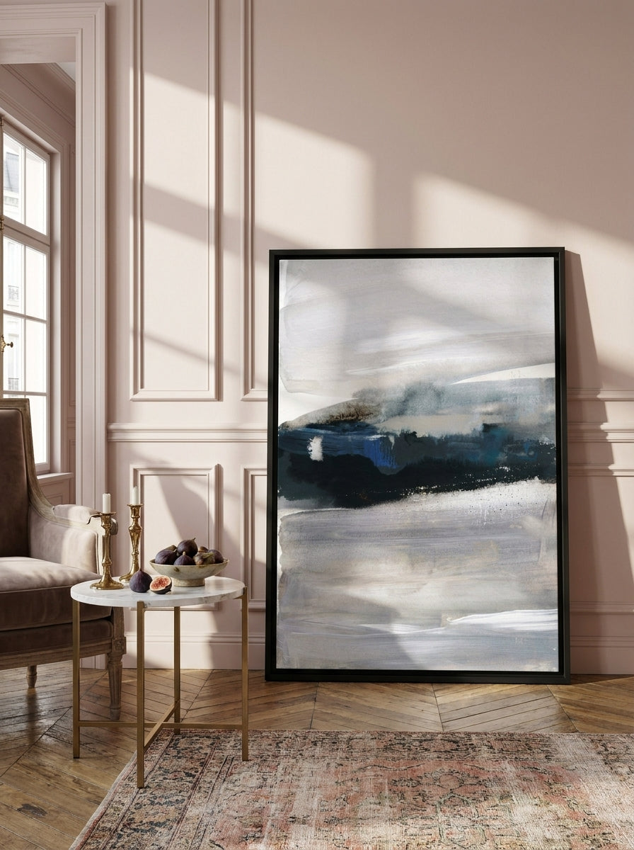 Canvas wall art with a black surround leaning against the wall in a Parisian living room