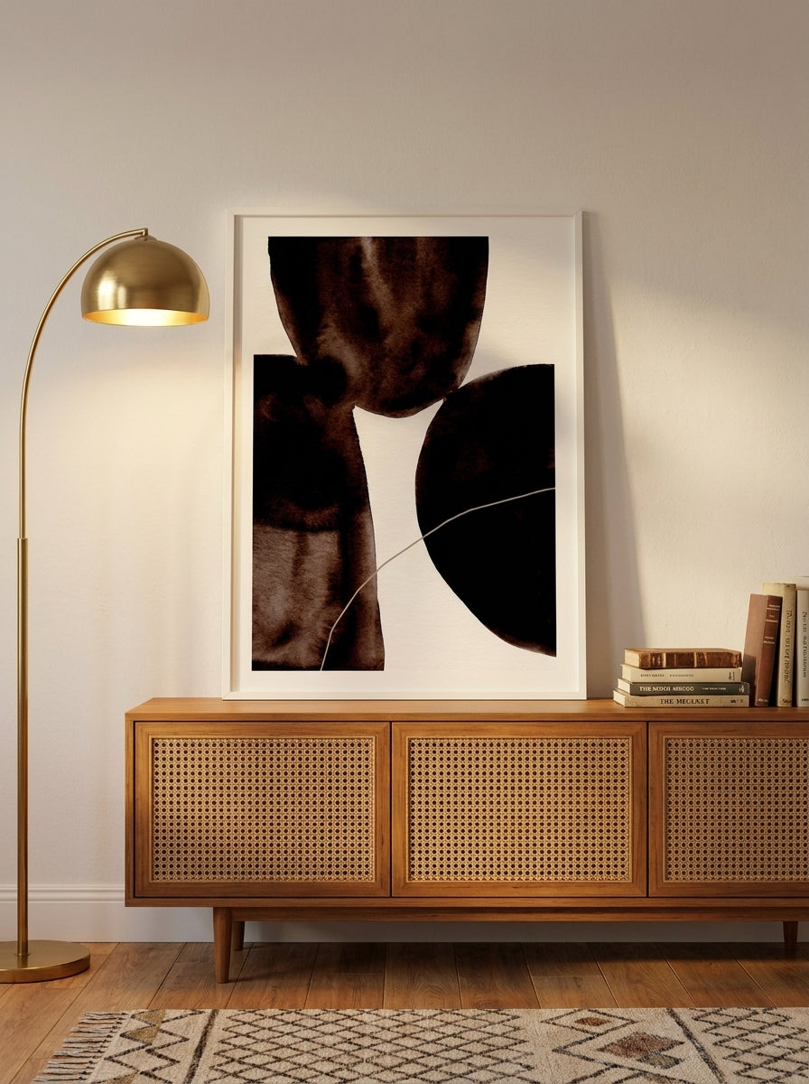 Modern wall art print standing on a sideboard in a mid-century bedroom