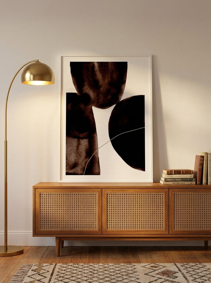 Modern wall art print standing on a sideboard in a mid-century bedroom