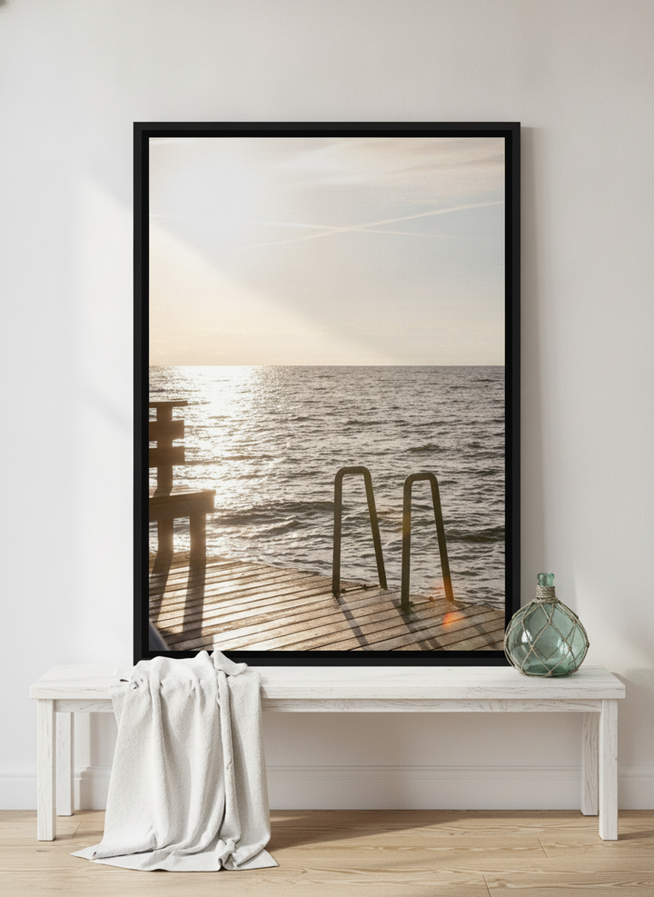 Canvas wall art with a black surround standing on a console in a coastal bathroom
