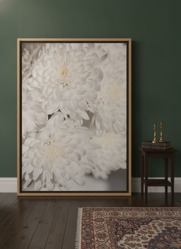 Oversized statement canvas wall art with a natural timber surround leaning against the wall in a moody living room