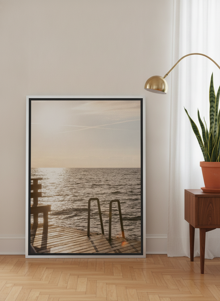Canvas wall art with a silver leaf surround leaning against the wall in a mid-century living room