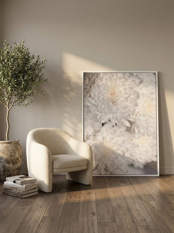 Oversized statement canvas wall art with a white surround leaning against the wall in a luxe living room