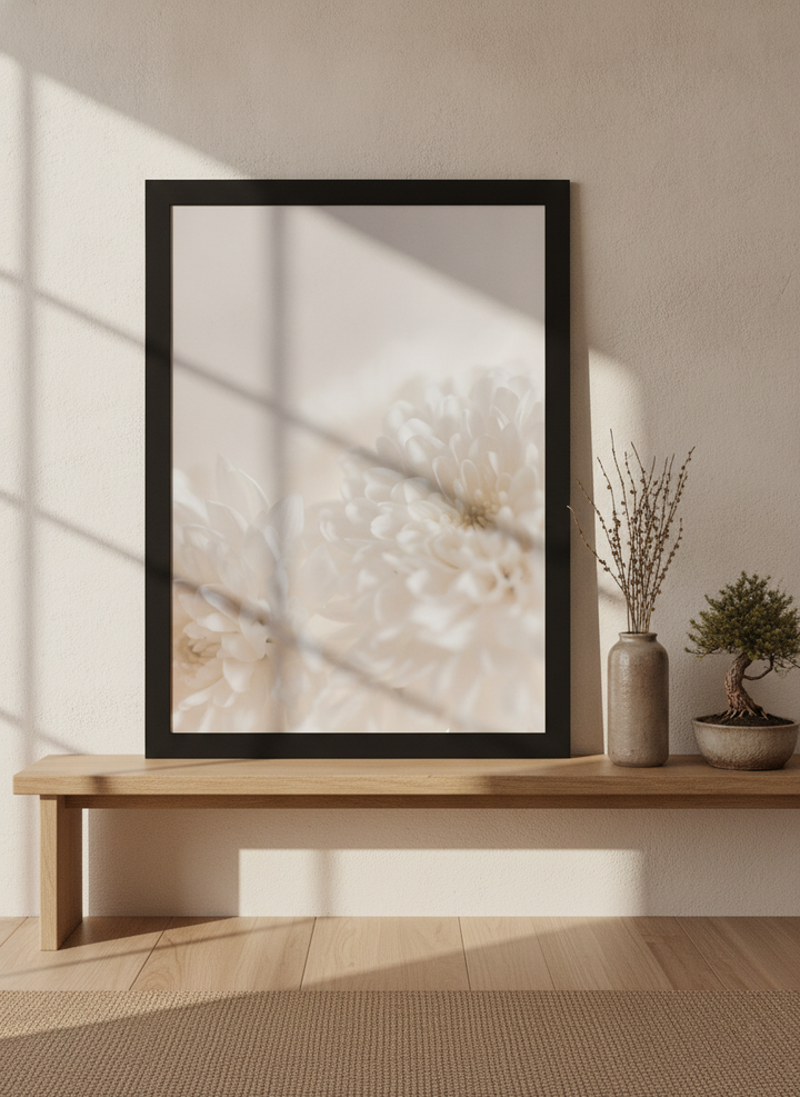 Modern wall art print standing on a bench in a warm Japandi bathroom