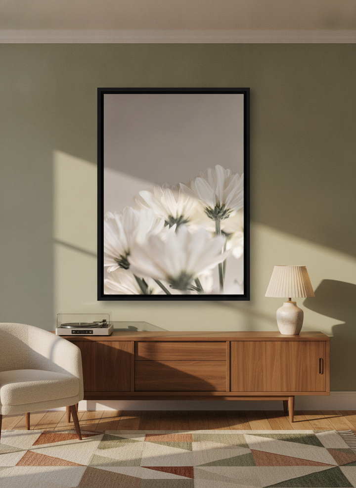 Oversized statement canvas wall art with a black surround styled on the wall in a mid-century living room